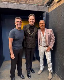 Simon Cowell, Max Fox, and Bruno Tonioli posing together.
