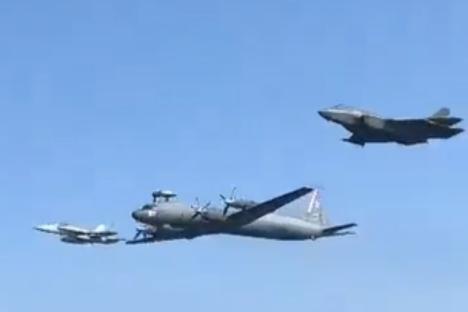 Heart-stopping vid shows Russia spyplane intercepted by US jets while swooping low over aircraft carrier in sea clash