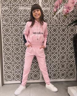 Girl in pink tracksuit.