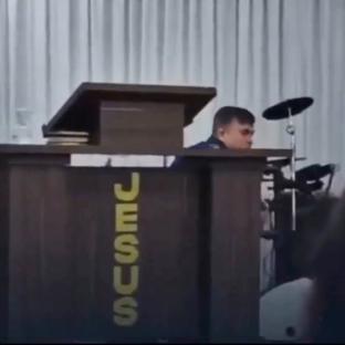 Pastor collapsing at a podium during a sermon.