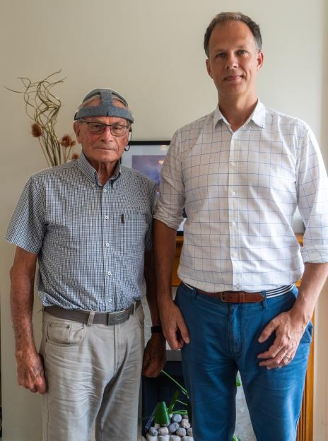 Photo of Dr. George Stothart and volunteer John Stennard; Stennard is wearing a device for an EEG brainwave test.