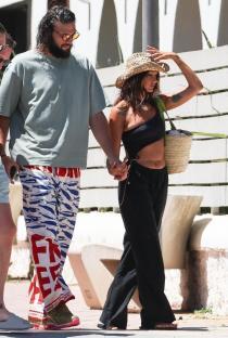 Andy Carroll and Lou Teasdale walking with a friend in Ibiza.