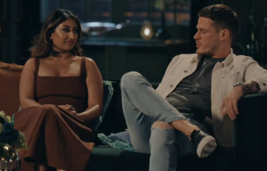 Nelly and Steven on a couch, having a serious conversation.