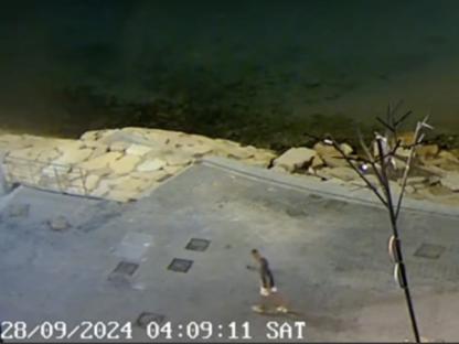 CCTV image of Nathan Osman walking near a cliff edge at night.