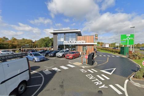 Body of woman in her 30s found at home after ‘car crashed into McDonald’s’ as cops arrest man on suspicion of murder