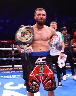Anthony Cacace celebrates with his IBO World Super Featherweight title belt.