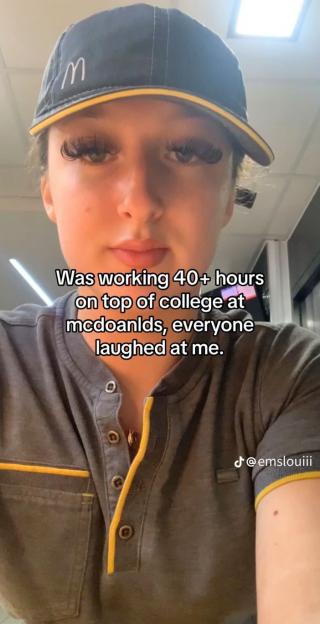 A young woman wearing a McDonald's uniform hat and shirt with text overlaid: "Was working 40+ hours on top of college at mcdoanlds, everyone laughed at me."