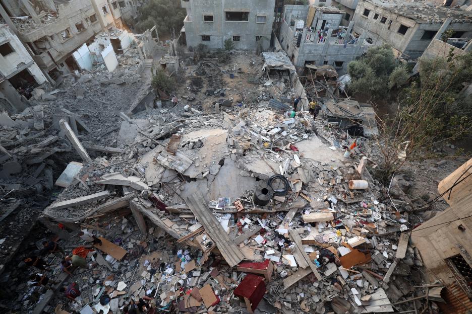 Aerial view of Palestinians checking the rubble of a building destroyed by an Israeli strike in the Nuseirat refugee camp.