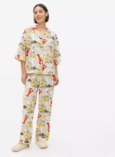 Woman modeling a lemon and lobster print pajama set.
