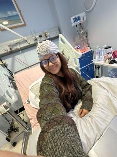 Woman in hospital bed wearing a turban.