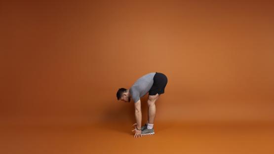 Man performing a forward bend stretch.