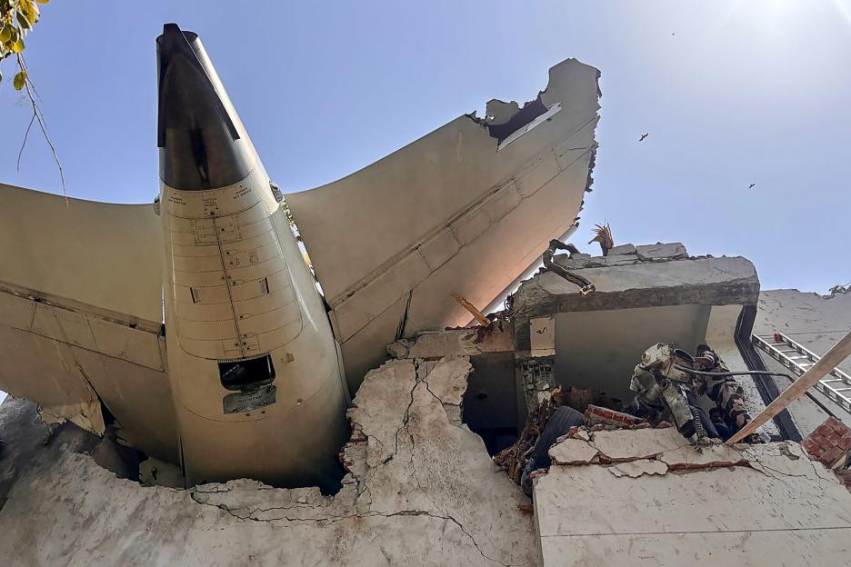 The back of an Air India plane crashes into a residential building.