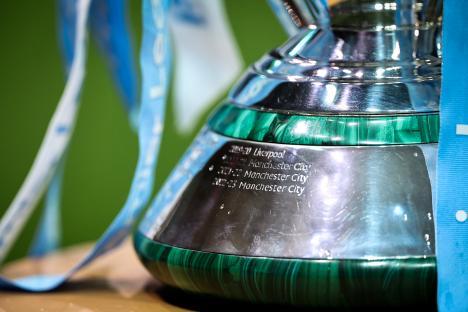 Close-up of the Premier League trophy base, showing engravings of Manchester City's wins.