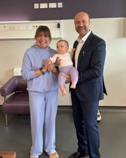 Lorraine Kelly and a man holding a baby.