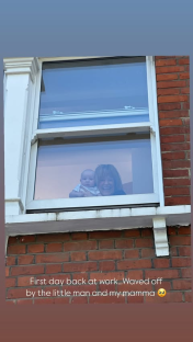 Baby and woman waving from window.