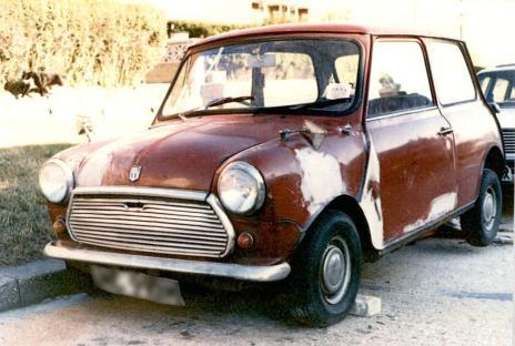 Photo of a red Austin Mini, partially repainted, associated with the