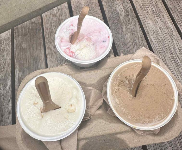 Three cups of ice cream: strawberry, vanilla, and chocolate.