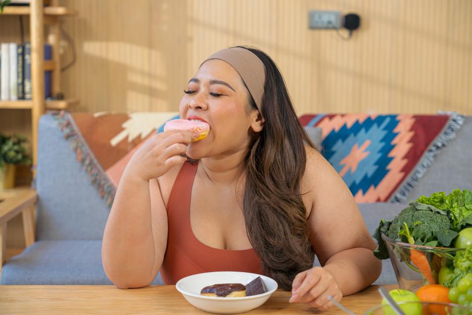 Woman eating a donut.