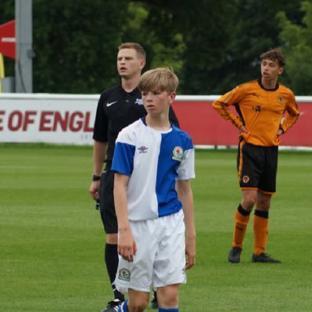 Three young soccer players on a field.