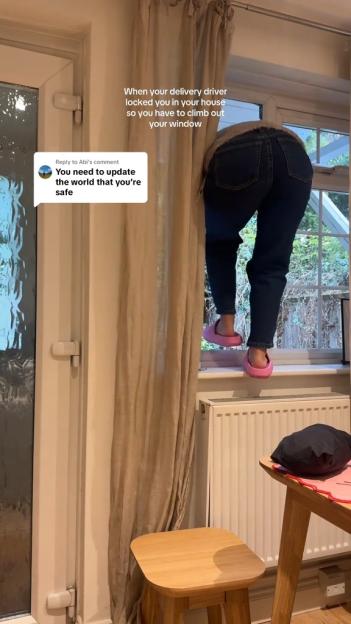 A person in jeans and pink slippers climbing out of a window because a delivery driver blocked their door.