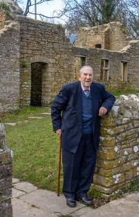 Peter Wellman, the last resident of Tyneham, standing by the ruins of his childhood home.