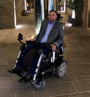 Man in wheelchair celebrating his birthday.