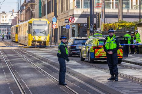 Police officers at the scene of a tram and van accident.