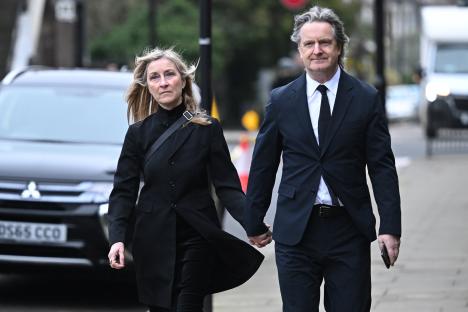 Fiona Phillips and Martin Frizell attending a funeral.