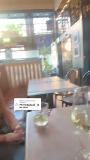 Video of a person at a restaurant table with drinks.