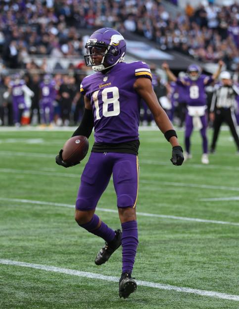 Justin Jefferson of the Minnesota Vikings holding a football.