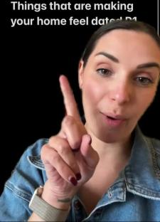 Woman pointing up while discussing dated home design trends.