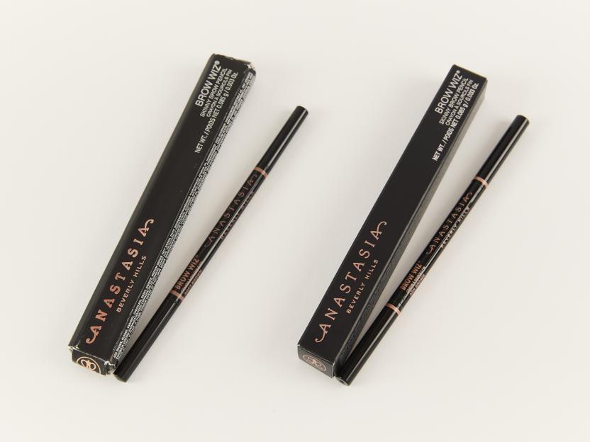 Two "Anastasia Beverly Hills Brow Wiz" brow pencils and their boxes, the left one labeled "Soft Brown" and the right one "Ash Brown".