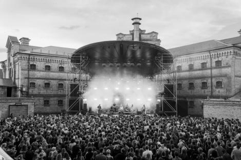 Black and white photo of a large crowd at an outdoor concert.