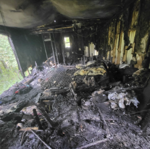 The charred interior of a room after a fire.