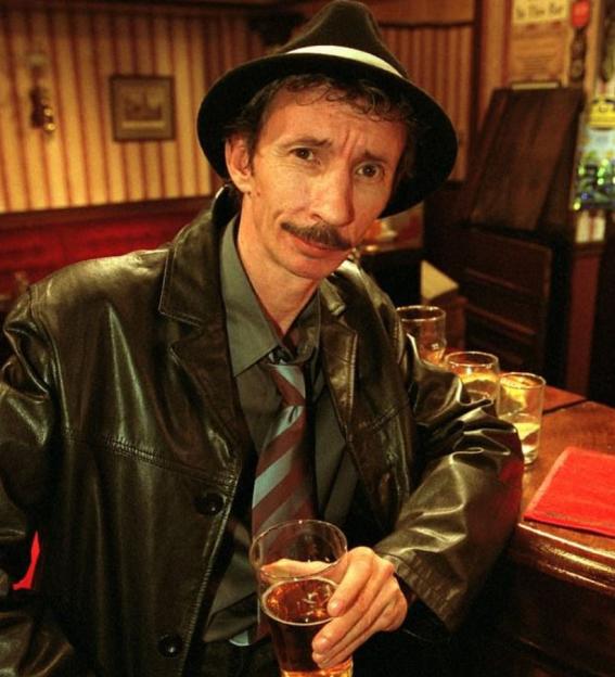 Patrick Murray as Micky Pearce from Only Fools and Horses, holding a pint glass.