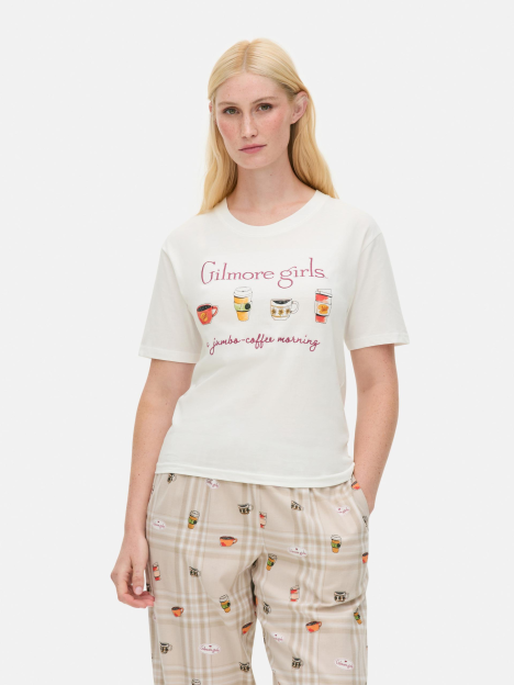 Woman in Gilmore Girls pajamas and t-shirt.