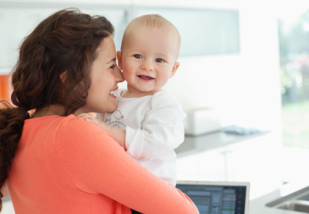 Smiling mother holding her baby.