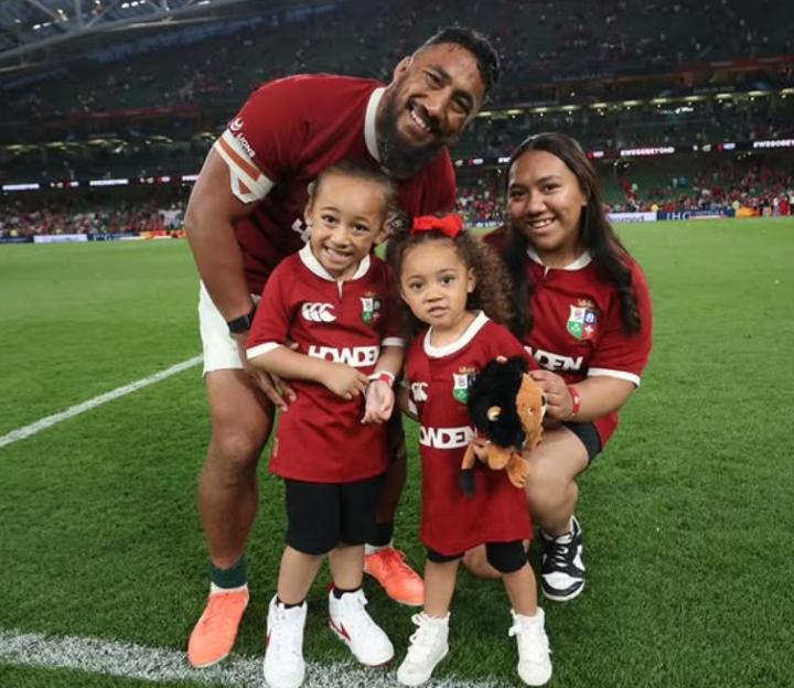 Bundee Aki and his family at a rugby stadium.