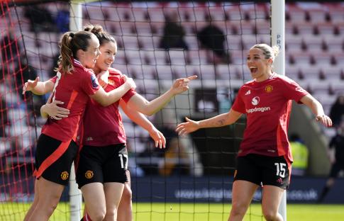 Manchester United women's soccer players celebrating a goal.