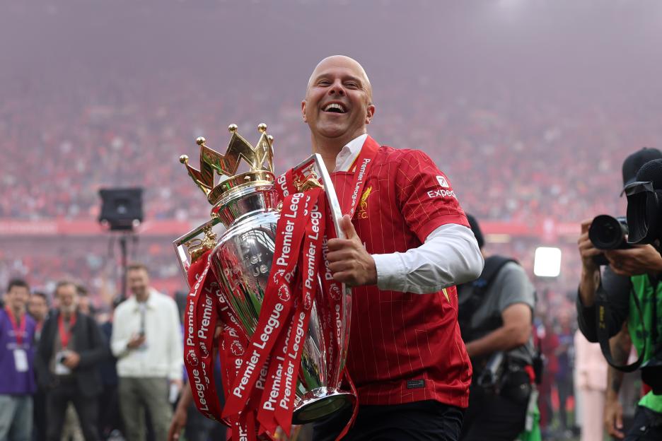 Arne Slot, Liverpool manager, celebrates with the Premier League trophy.