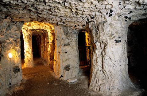 Interior of the Naours Caves, showing a network of tunnels and chambers carved into rock.