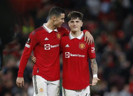 Cristiano Ronaldo and Alejandro Garnacho celebrating after a Manchester United soccer match.
