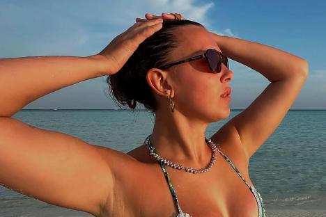 Millie Bobby Brown wows in tiny bikini on the beach weeks after hitting back at trolls over red carpet appearance
