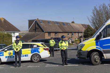 Police officers at a murder scene in Hollingbury, Brighton.
