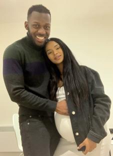 Portrait of a pregnant woman and man embracing.