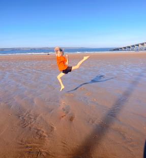 Girl jumping on a beach.