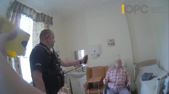 Bodycam footage of police officers using force against a 92-year-old man in a wheelchair.