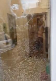 Security camera footage of a man in scuba gear during a rampage.