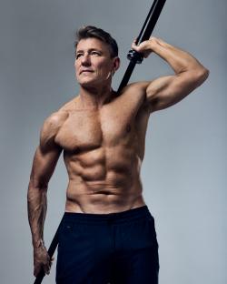 Muscular man holding a barbell.