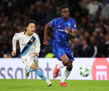 Chelsea's Tyrique George battling for possession during a soccer match.